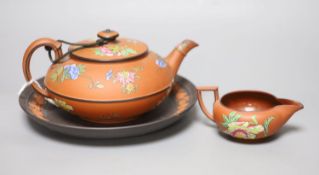 A Wedgwood enamelled terracotta teapot, milk jug and a basalt and rosso sprigged dish, diameter