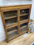 A Minty style glazed oak two section bookcase, width 87cm depth 19cm height 113cmCONDITION: Good