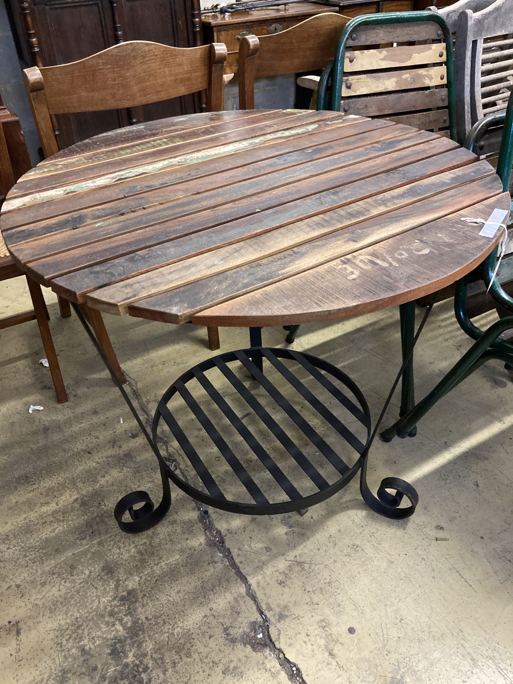 A circular slatted wood and wrought iron garden table, 85cm diameter, height 78cm together with a - Image 2 of 5