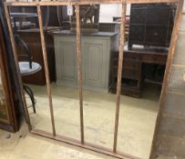 An industrial style metal framed wall mirror, width 131cm, height 135cm