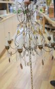 An eight branch glass drop chandelierCONDITION: Made from gilt-painted metal and glass. The gilt has