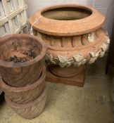 A circular terracotta garden planter on stand, diameter 56cm, height 50cm together with three