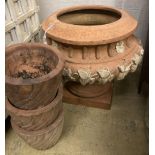 A circular terracotta garden planter on stand, diameter 56cm, height 50cm together with three