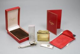 A cased Must de Cartier lighter, one other and two cigar cutters