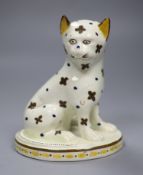 A rare large Staffordshire pearlware figure of a cat, c.1790-1800, seated on an oval base, 14.7cm