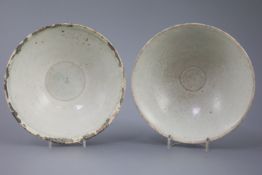 Two Chinese Qingbai bowls, Song dynasty, the first incised with foliage to the interior, the