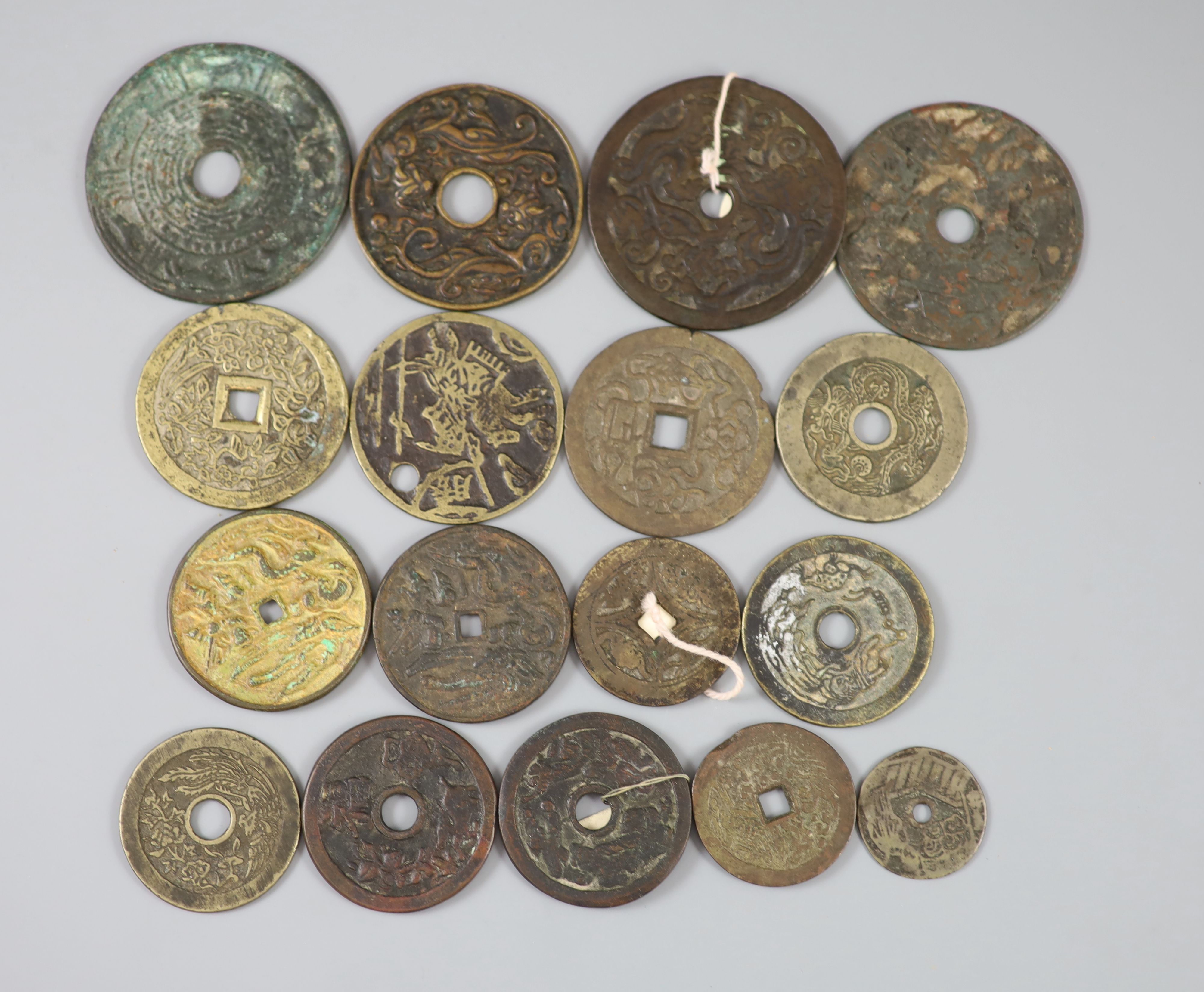 China, 17 bronze or copper charms or amulets, Qing dynasty or earlier, fifteen with pictorial