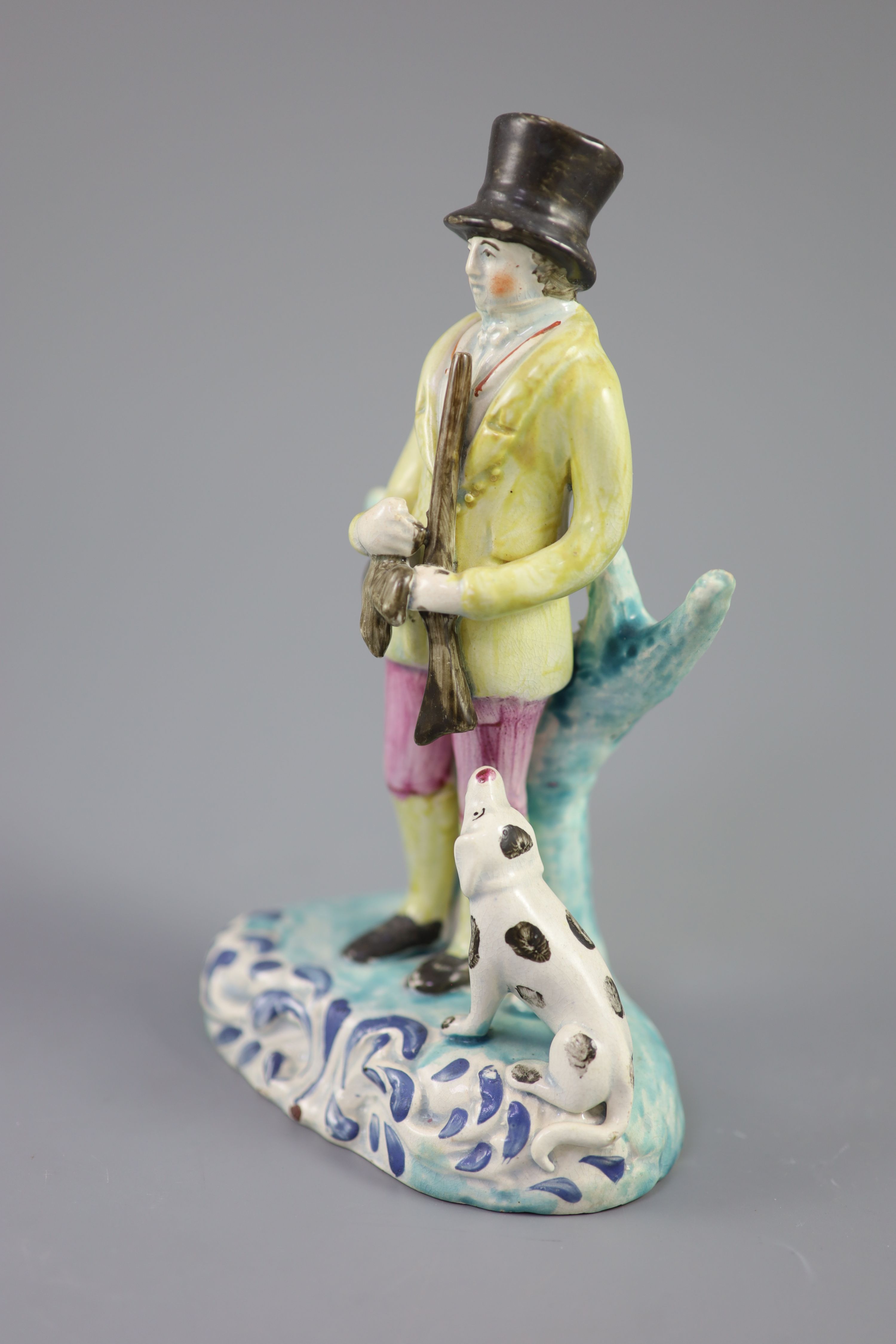 A Staffordshire pearlware group of a huntsman with dog and gun, c.1820-30, on a turquoise and blue - Image 2 of 4