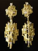 A pair of early 1970's 18ct gold and seven stone diamond set modernist rustic drop ear clips, by