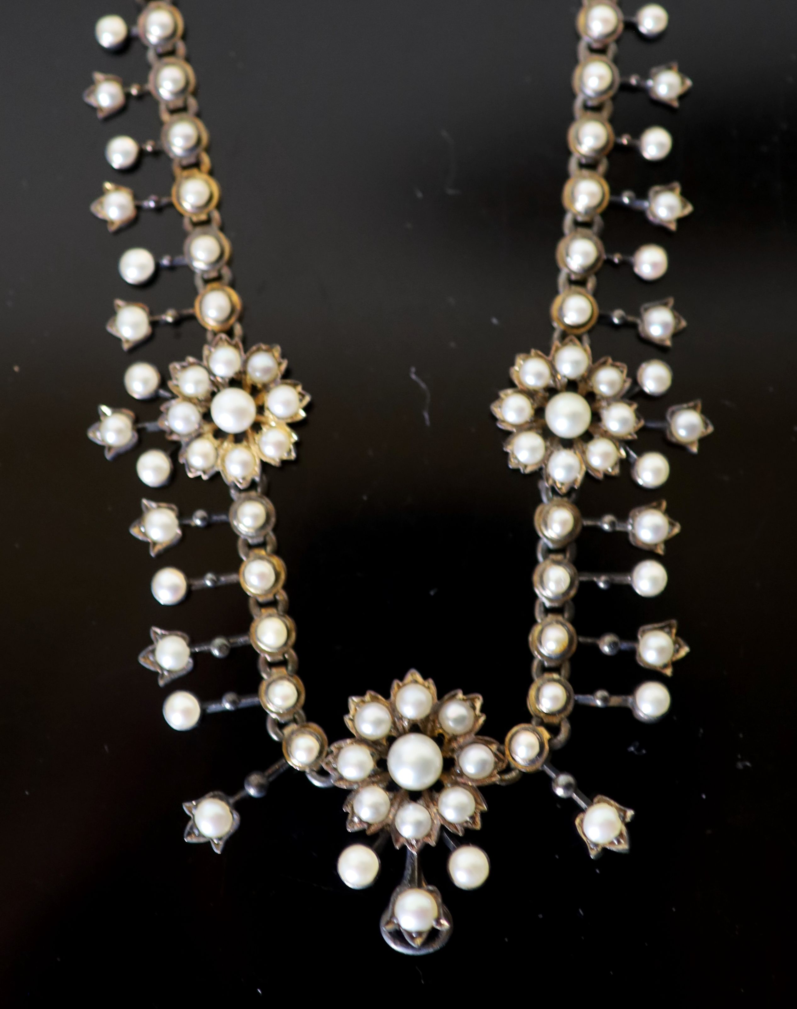 An Edwardian gold and pearl set necklace, lacking pendant attachment, 40cm, gross weight 30 grams.