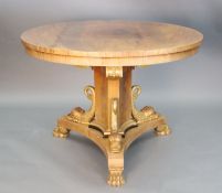 A Regency style mahogany centre table, with circular top, on concave sided triangular stem,