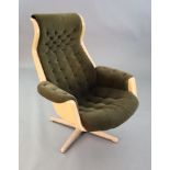 A Svensson and Sandstrom Swedish moulded plastic chair, upholstered in buttoned brown fabric with