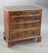 An early 18th century oyster veneered chest, of two short and three graduated long drawers, on later