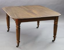 A Victorian mahogany extending dining table, with rounded rectangular top and three spare leaves, on