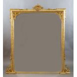 A Victorian gilt gesso overmantel with pierced scallop and scroll crest and foliate motif