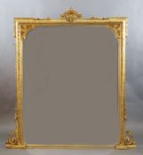 A Victorian gilt gesso overmantel with pierced scallop and scroll crest and foliate motif