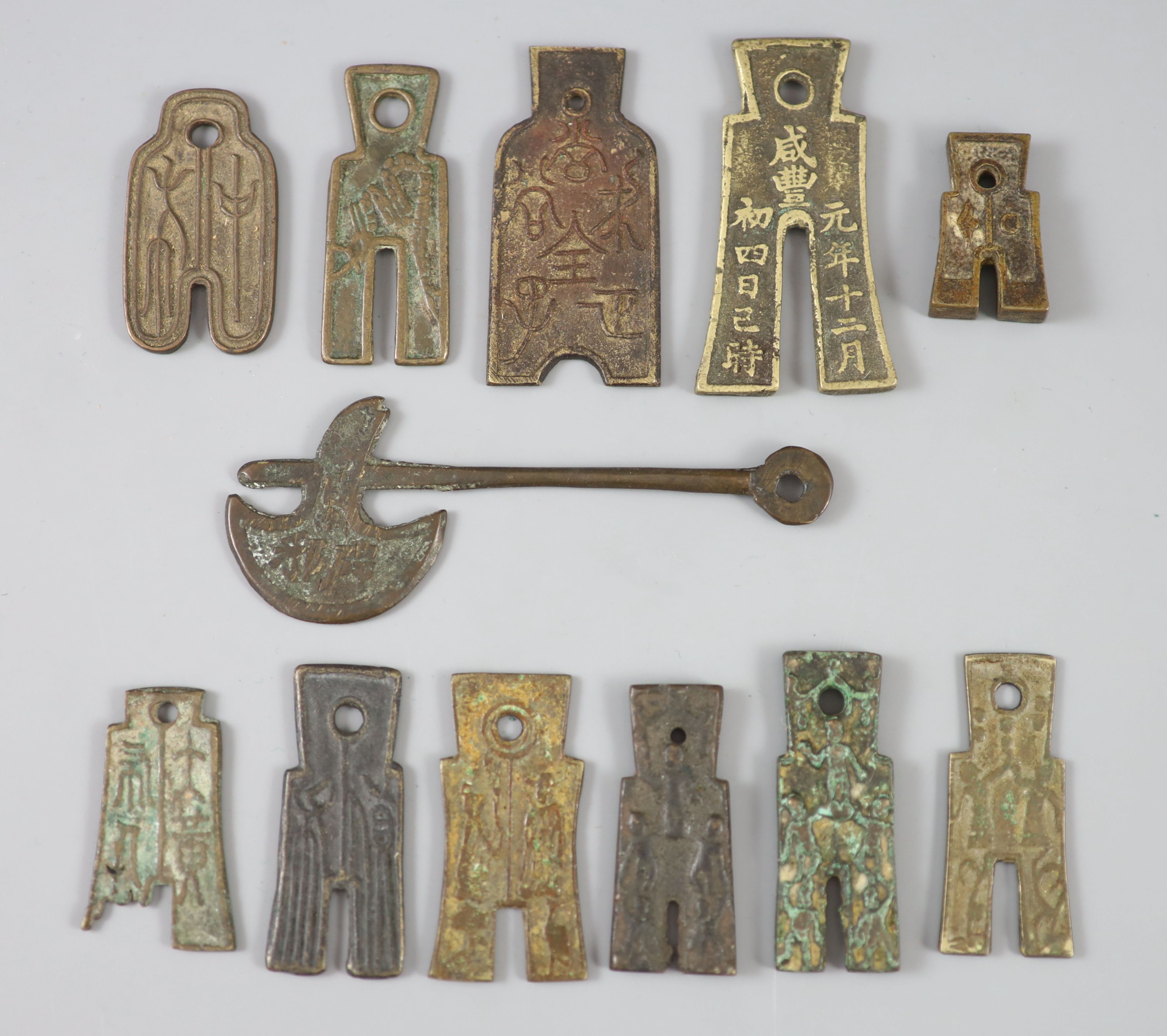 China, 11 bronze spade shaped charms or amulets, Qing dynasty, 31-61mm, F to VF, together with a