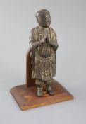 A Chinese bronze figure of Shancai Tongzi, late Ming dynasty, standing and holding his hands