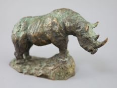 § Hamish Mackie (1973-). A bronze model of a rhinoceros, standing upon a naturalistic base,