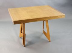 A Guillerme & Chambron golden oak draw leaf dining table, with extending rectangular top on stylised