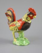 A Staffordshire pearlware figure of a cockerel, c.1820, on a naturalistic mound base, 19cm