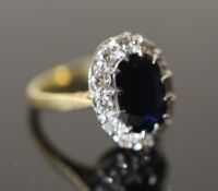 A 20th century 18ct gold, sapphire and diamond set oval cluster ring, size I, gross 3.9 grams.