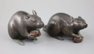 A pair of Japanese bronze models of rats, Meiji period, signed each holding a chestnut, inscribed