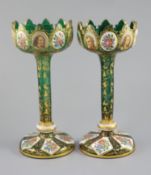 A pair of Bohemian enamelled white overlaid green glass vases, late 19th century, with crenellated