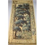 A 17th century Flemish verdure tapestry wall hanging, with central panel of trees withing flower and