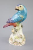 A Meissen model of a parrot seated on a tree stump, late 19th century, its head turned to Dexter,