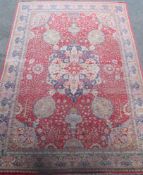 A Kirman carpet, the claret field with overall flowering shrub and palmette design centred by an