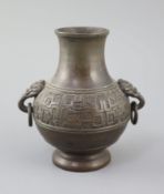 A Chinese archaistic bronze vase, 17th/18th century, cast in low relief with a band of scrolling