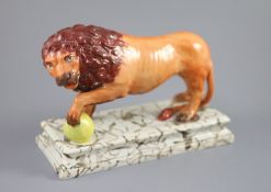 An Enoch Wood pearlware figure of a Medici Lion, c.1800-10, with paw on a golden ball, on a