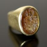 A 20th century continental 18ct gold (stamped 750) and oval citrine? intaglio signet ring, carved