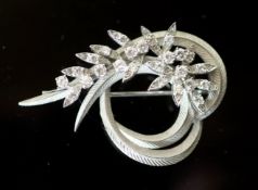 A mid 20th century French 18ct white gold and diamond set foliate scroll clip brooch, with