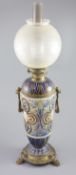 A large Doulton Lambeth stoneware oil lamp, by Edith D. Lupton, dated 1880, decorated with cherub