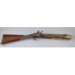 A late 18th century brass barrelled flintlock blunderbuss, by Jones, with chequered mahogany