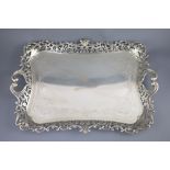 A George V silver two handled tea tray by Albert Henry Thompson, with engraved scrolling