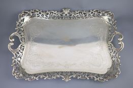 A George V silver two handled tea tray by Albert Henry Thompson, with engraved scrolling