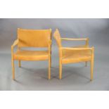 A pair of Swedish Varufakta tan leather and golden oak armchairs, W.2ft 1in. D. 2ft 1in. H.2ft 4in.