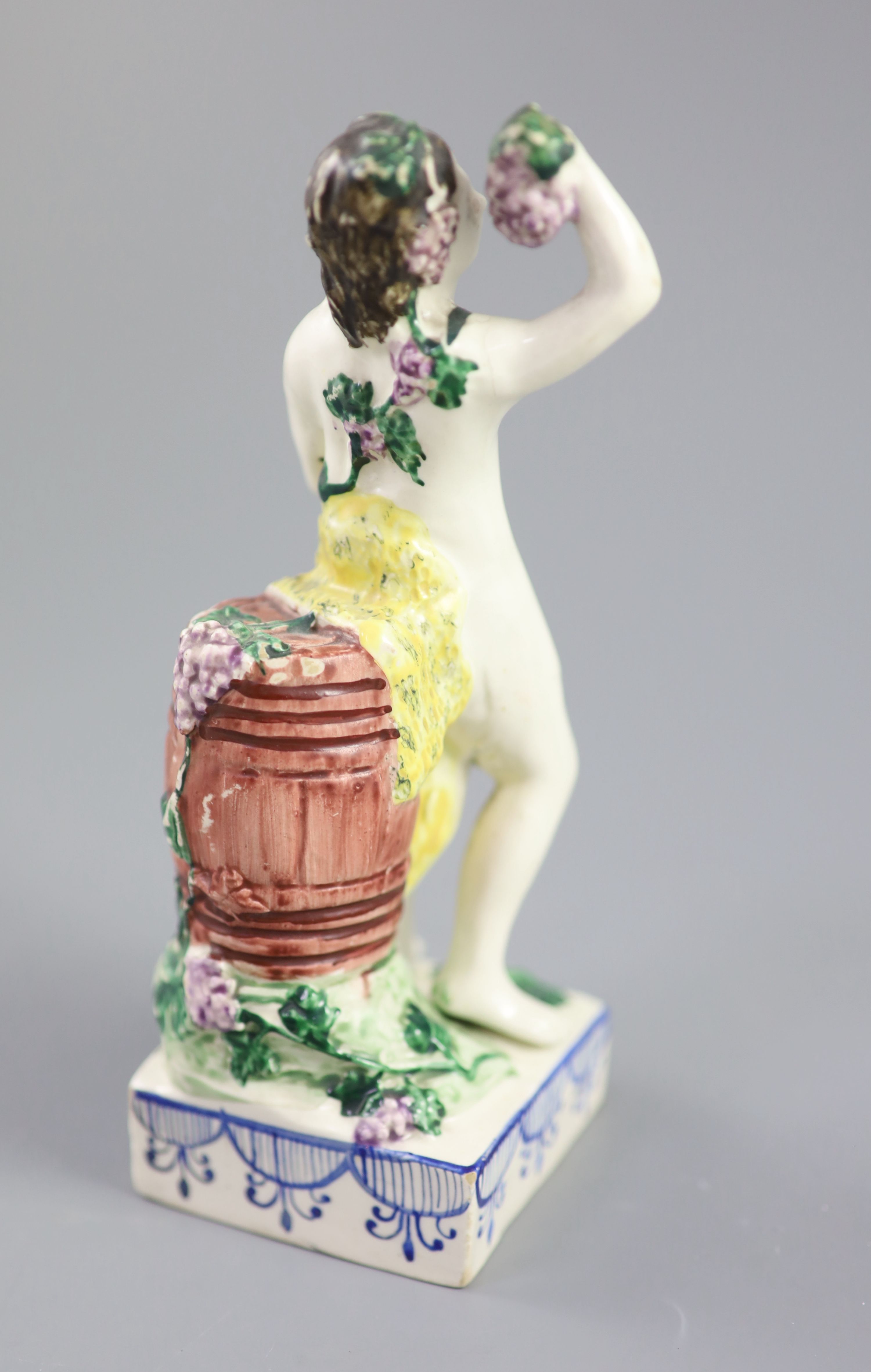 An enamelled creamware figure of Bacchus, attributed Leeds Pottery, c.1790-1800, standing by wine - Image 3 of 4