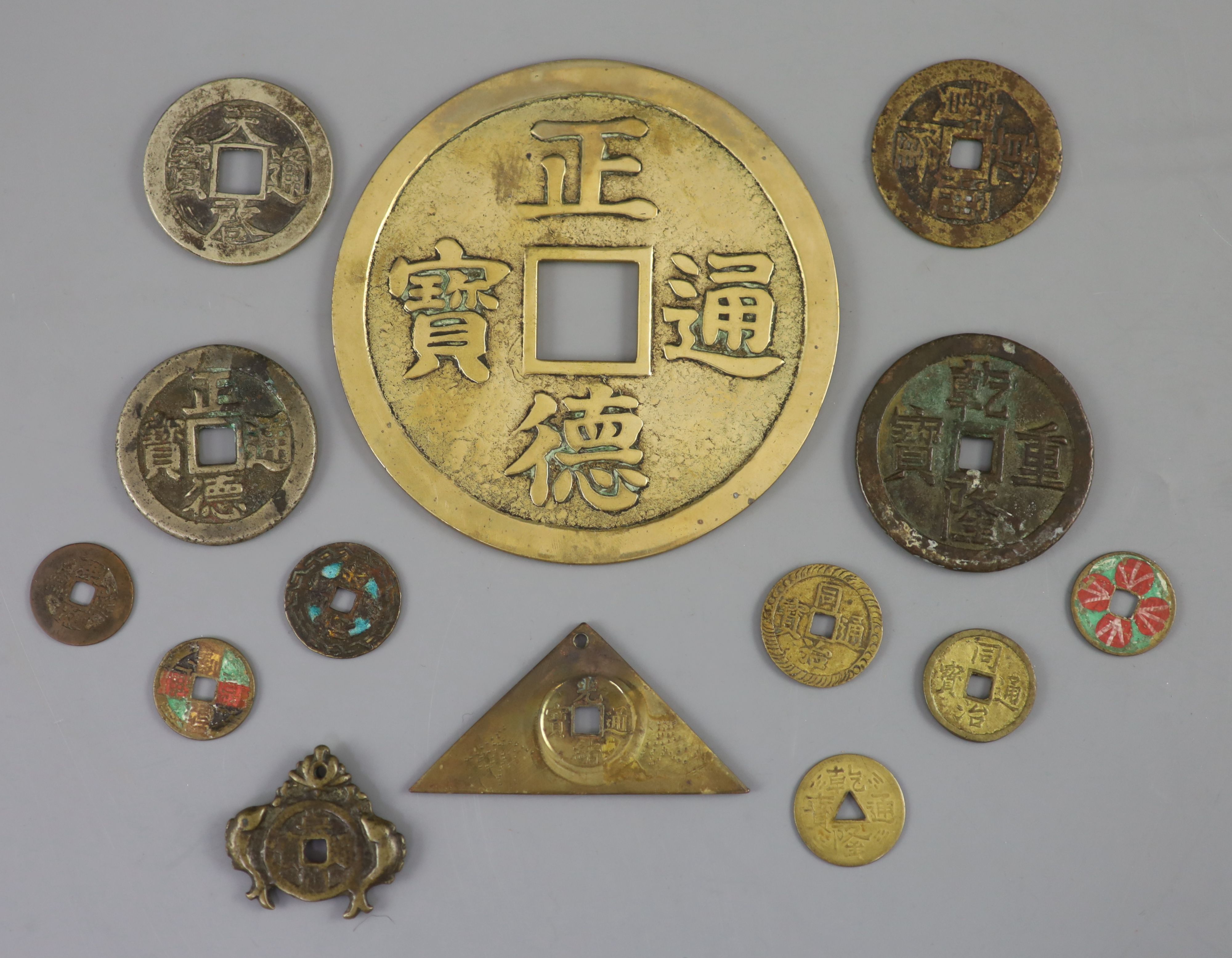 China, a group of 14 bronze and brass coin charms or amulets, Qing to Republic period, F to VF to