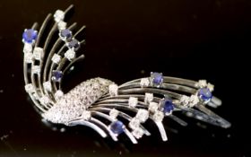 A platinum?, diamond and sapphire set spray brooch, set with round cut stones, 65mm, gross 19.3