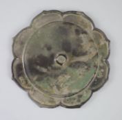 A Chinese bronze mirror, Song dynasty, eight petal lobed form, 16cm diameter