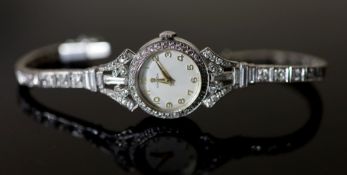 A lady's early 1960's 18ct gold, palladium and diamond set Omega manual wind cocktail watch, on