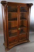 An Art Nouveau walnut and marquetry vitrine by Majorelle, with foliate carved and pierced columns