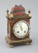 An early 20th century red tortoiseshell veneered mantel timepiece, with paste set bezel and ormolu