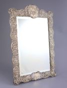 An Edwardian repousse silver mounted toilet mirror, Henry Matthews, Birmingham, circa, 1905,