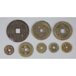 China, 8 bronze charms or amulets, Qing dynasty, six with four characters obverse and two reverse,
