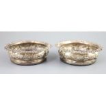 A pair of George IV silver wine coasters, S.C. Younge & Co, Sheffield, 1824, 16.7cm, embossed with